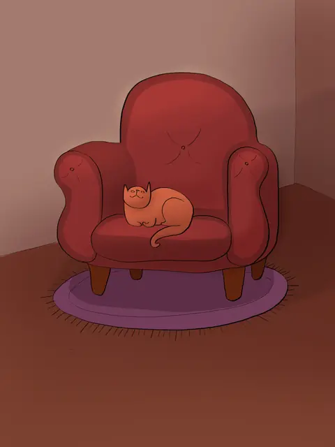 Orange cat asleep on a red armchair in a corner