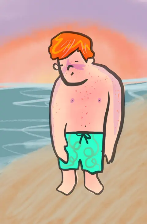 Sunburnt red-haired man in green swim trunks on a beach at sunset